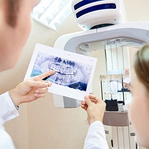 Dentist reviewing X-ray with patient