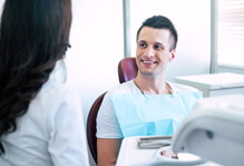 smiling patient talking to dental team member